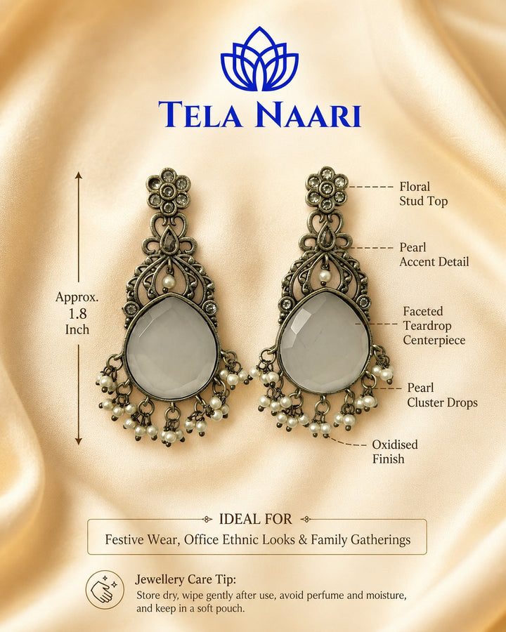 Artificial stone accents highlight the centre of this earring.