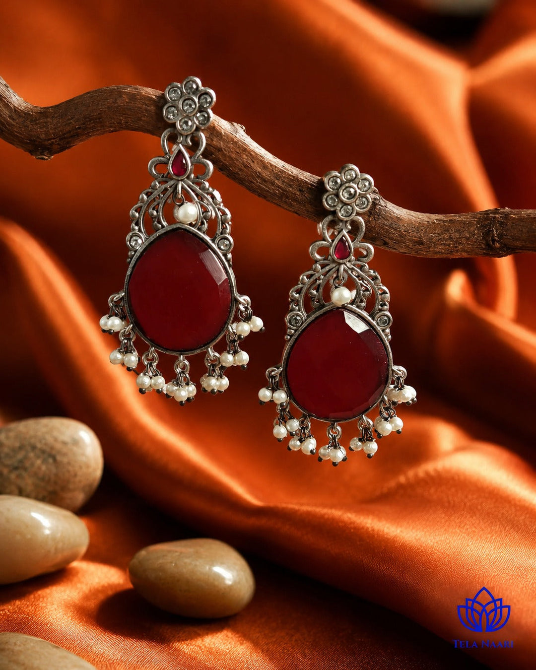 Delicate beadwork highlights the red and silver colour combination.