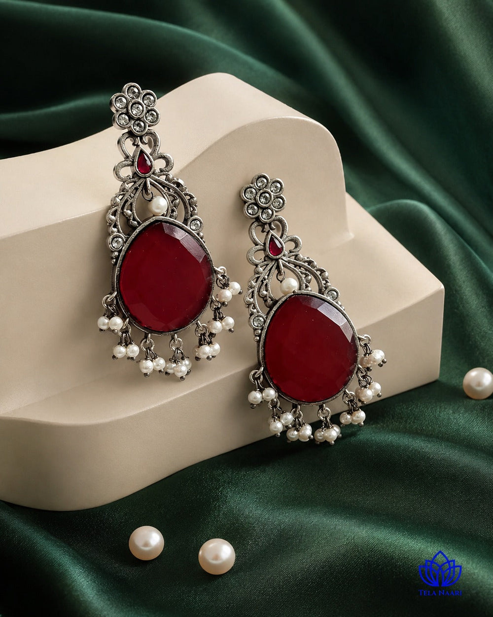 Glass bead accents add texture to this earring's red colour palette.