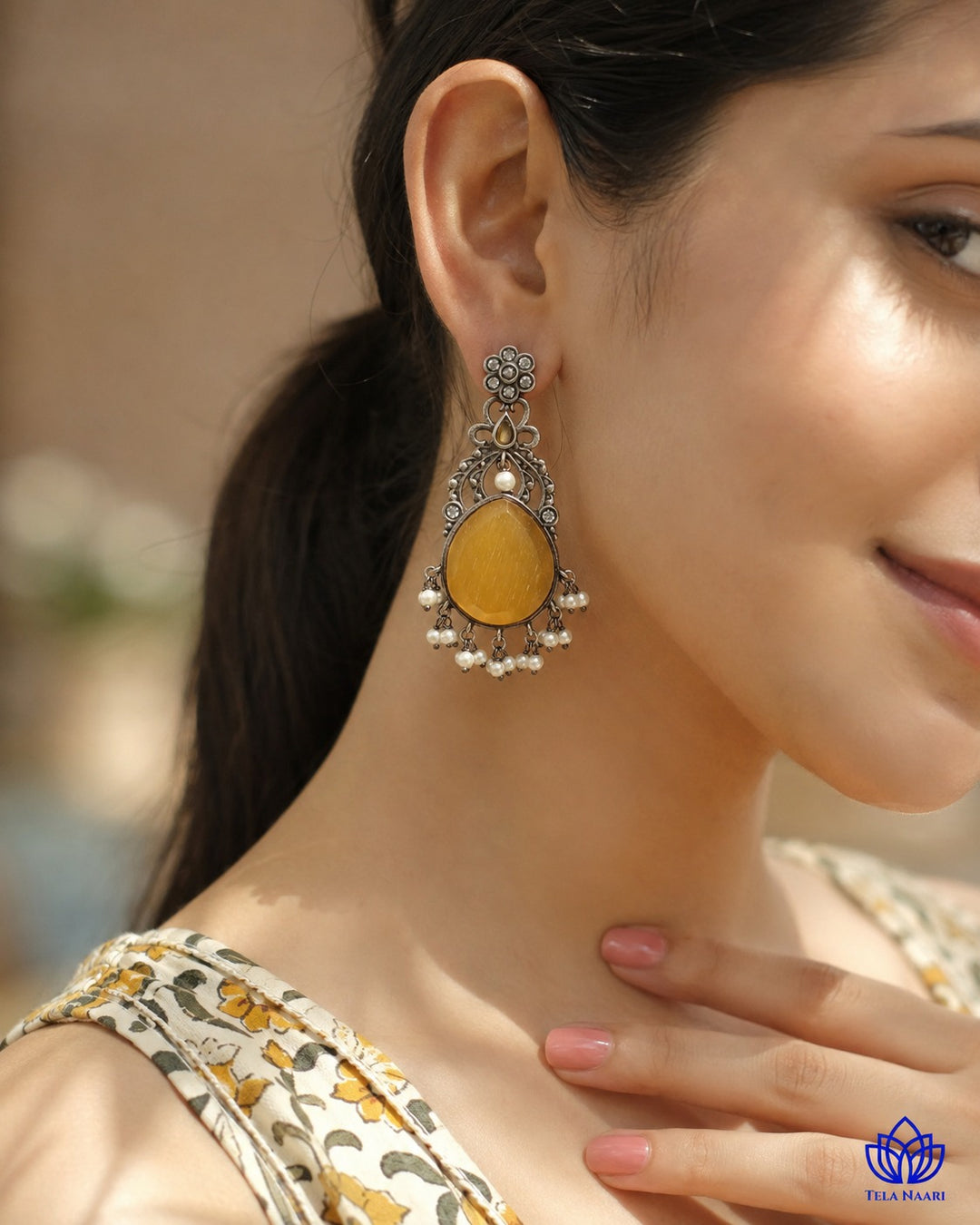Post and back closure secures this silver-plated yellow earring.