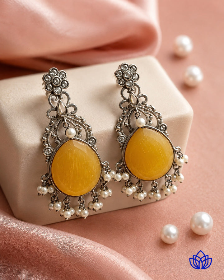 Silver-plated finish covers the surface of this yellow earring.