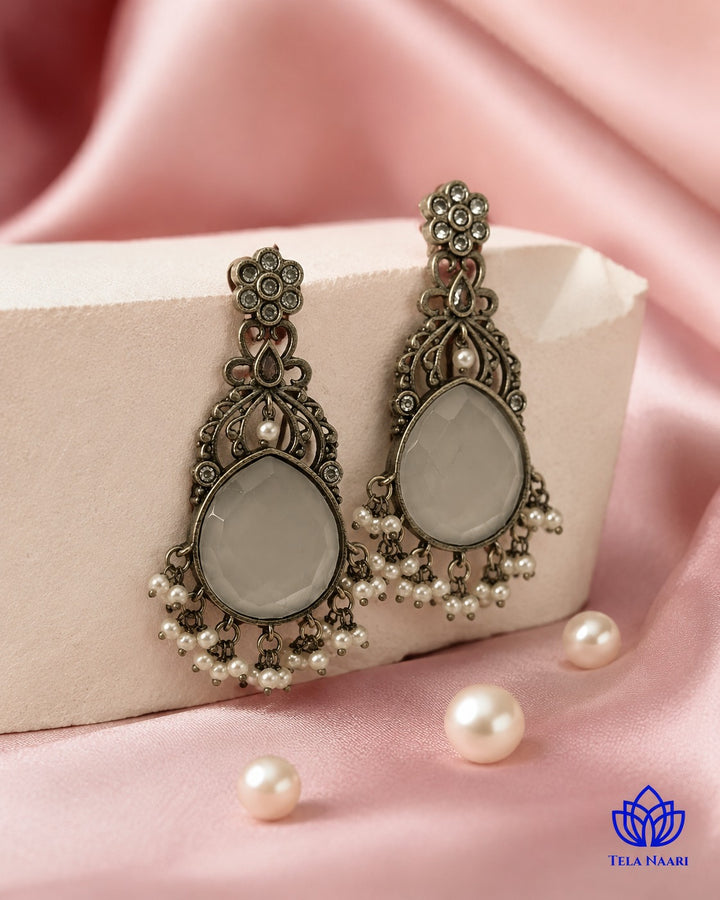 Versatile design pairs a silver-plated finish with soft white stones.