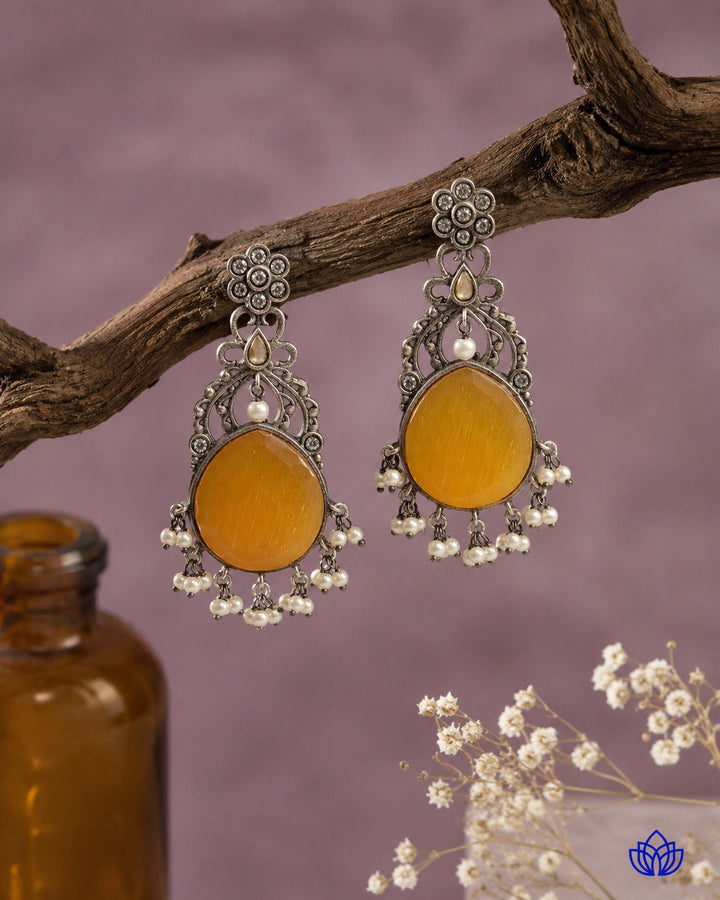 Versatile design pairs a silver-plated finish with vivid yellow stones.