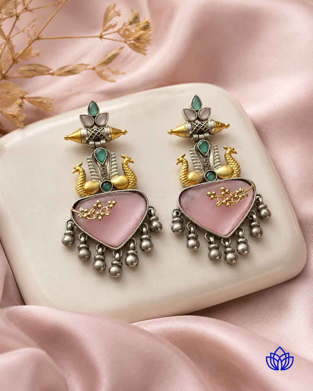 Soft pink stone sits at the centre of this statement earring.
