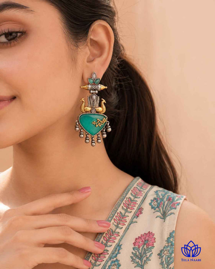 Bold silhouette showcases the dual-tone contrast of this earring.