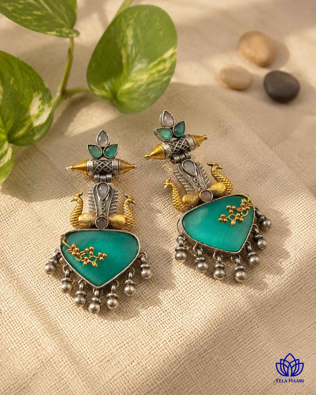 Soothing sea green tones brighten the dual-tone surface of this earring.