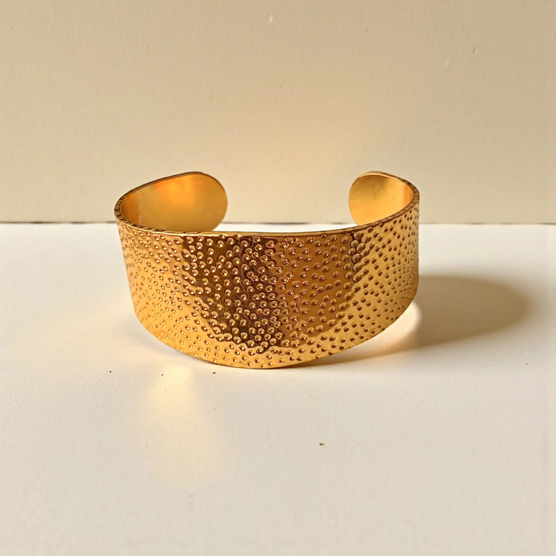 Stackable design lets this dotted cuff pair with other bracelets.