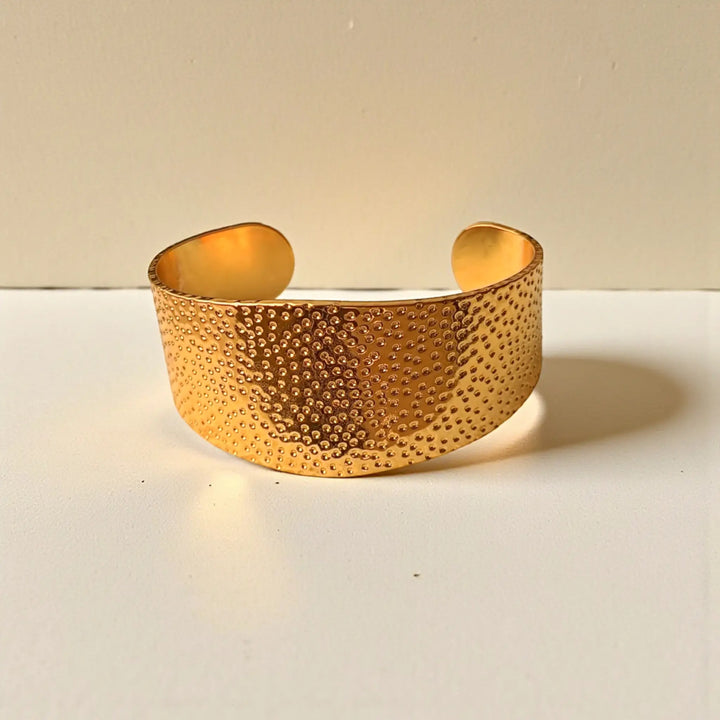 Stackable design lets this dotted cuff pair with other bracelets.