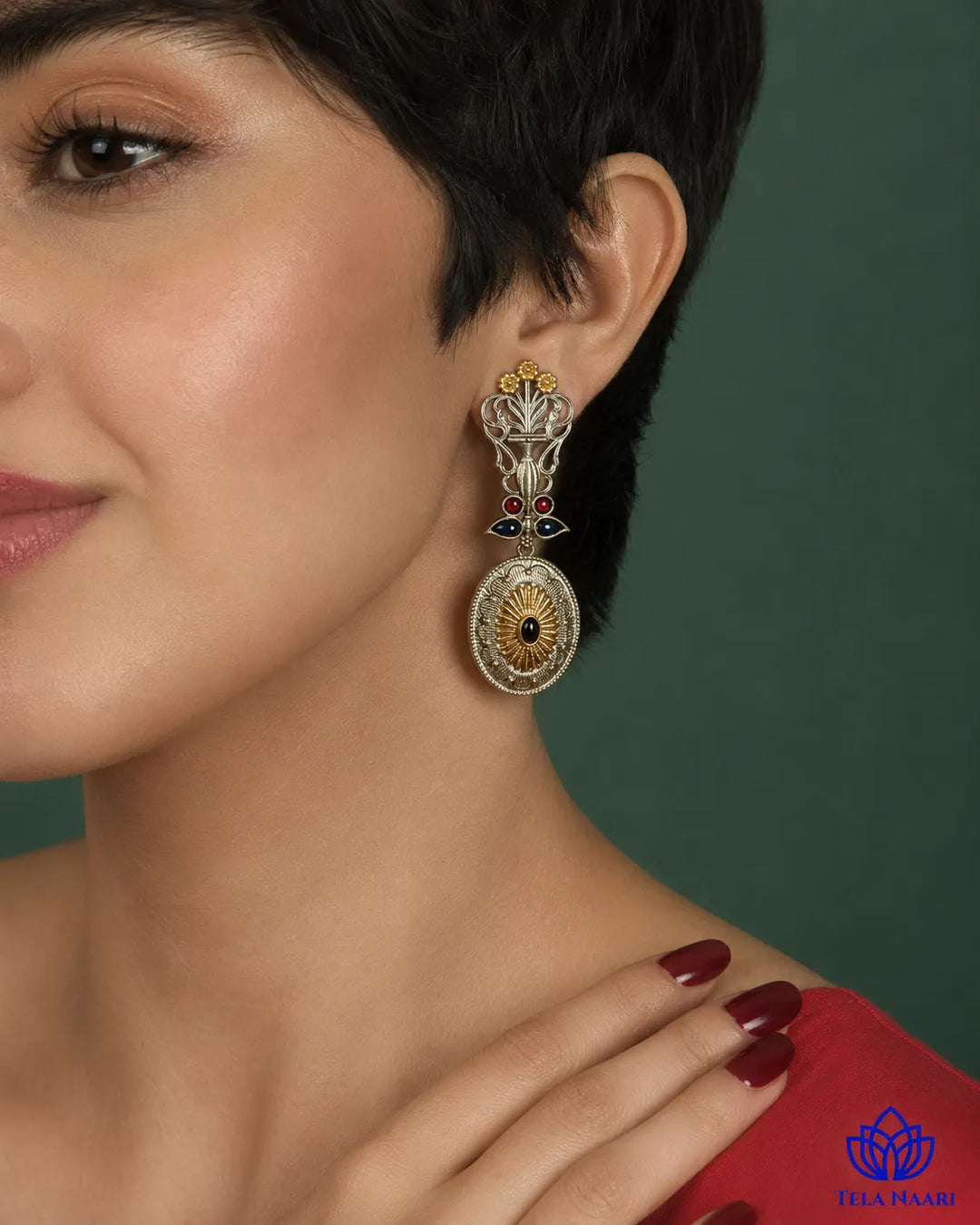 Bold peacock silhouette pairs oxidised and silver-plated finishes.
