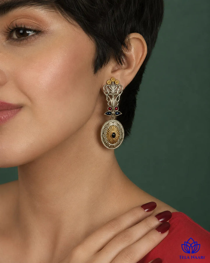 Bold peacock silhouette pairs oxidised and silver-plated finishes.