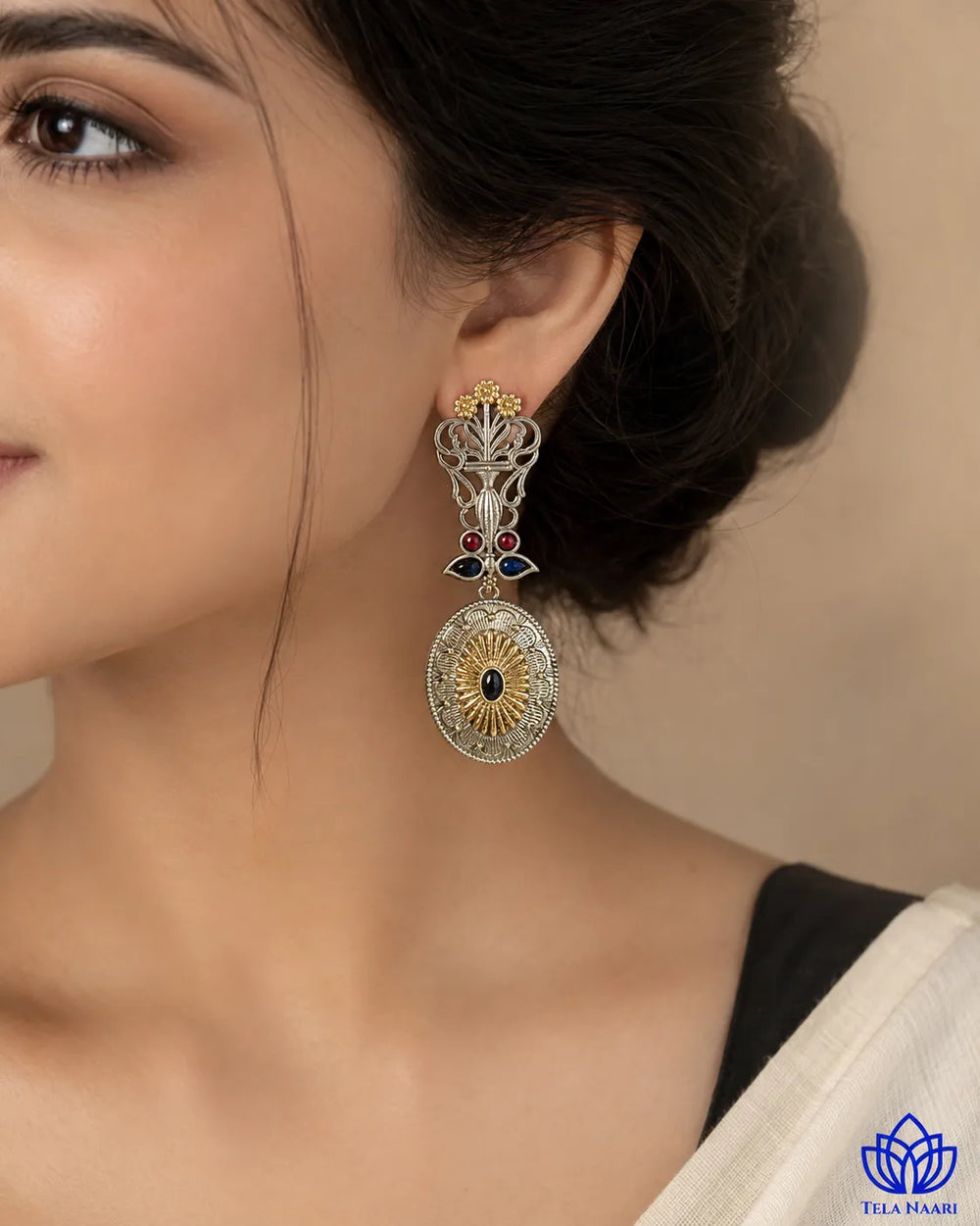 Oxidised finish covers half of this dual-tone peacock earring.