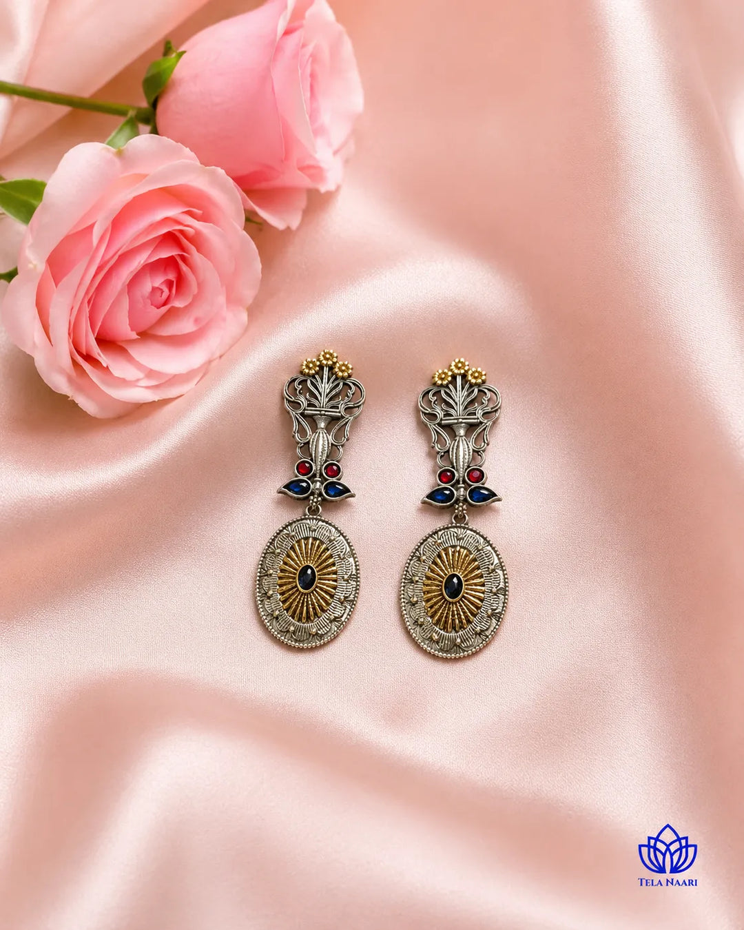 Luxurious peacock detailing shapes this dual-tone statement earring.