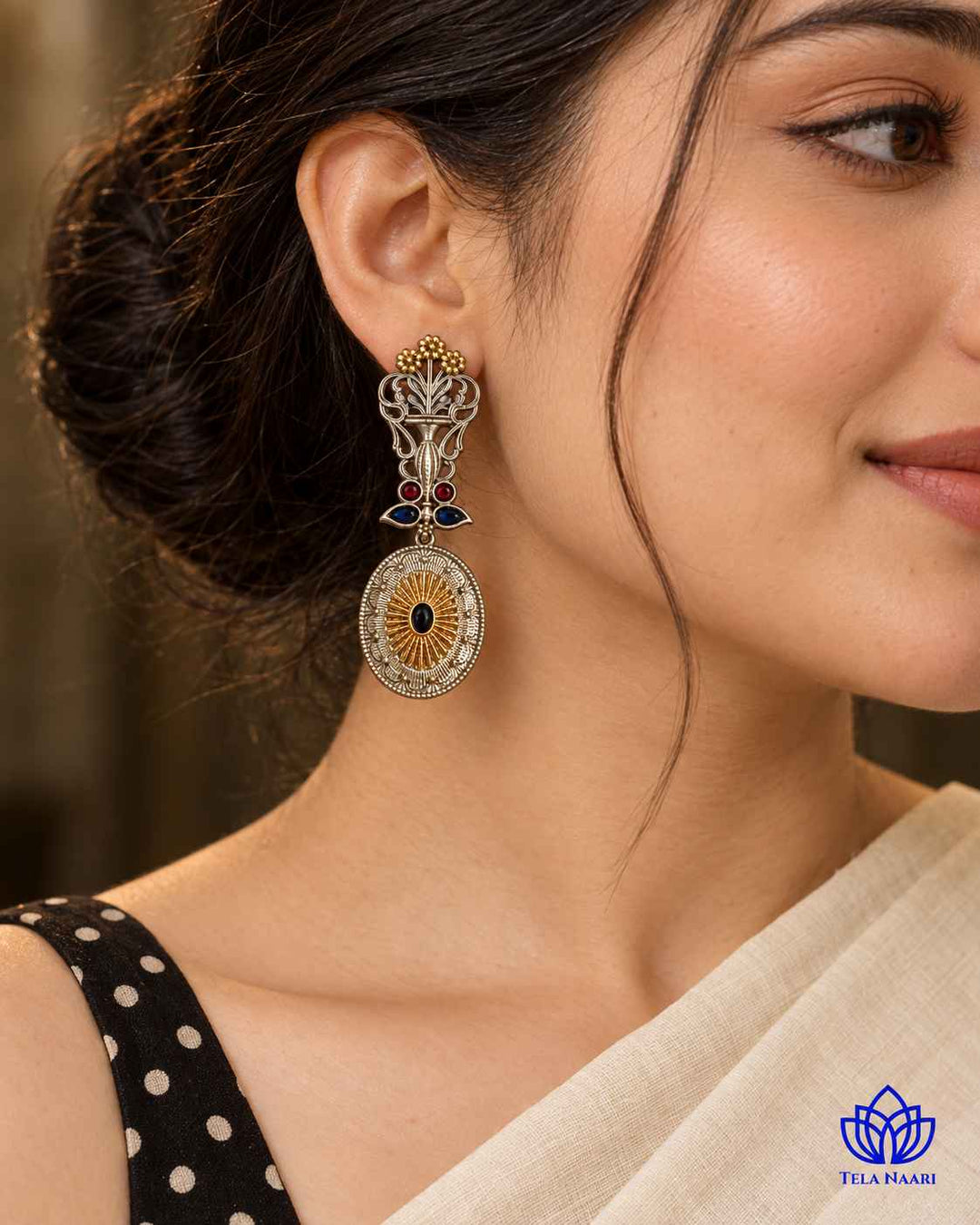Luxurious peacock detailing shapes this dual-tone statement earring.