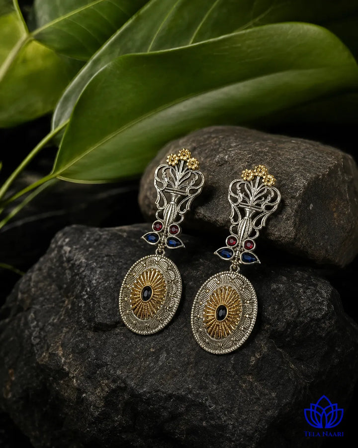 Push-back closure secures this dual-tone statement earring in place.