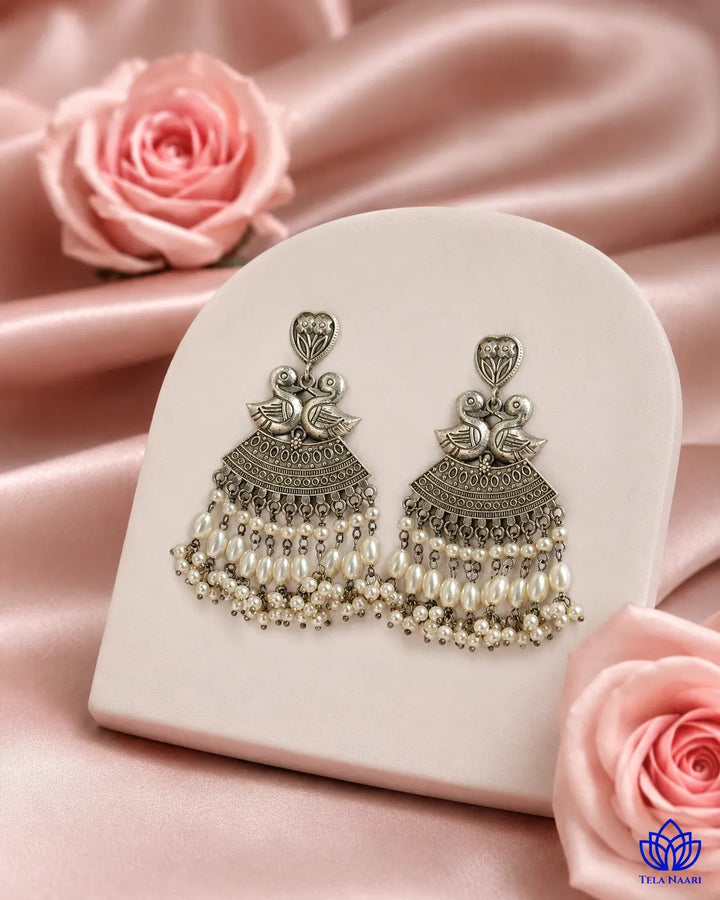 Antique detailing adds texture to this duck-motif earring surface.