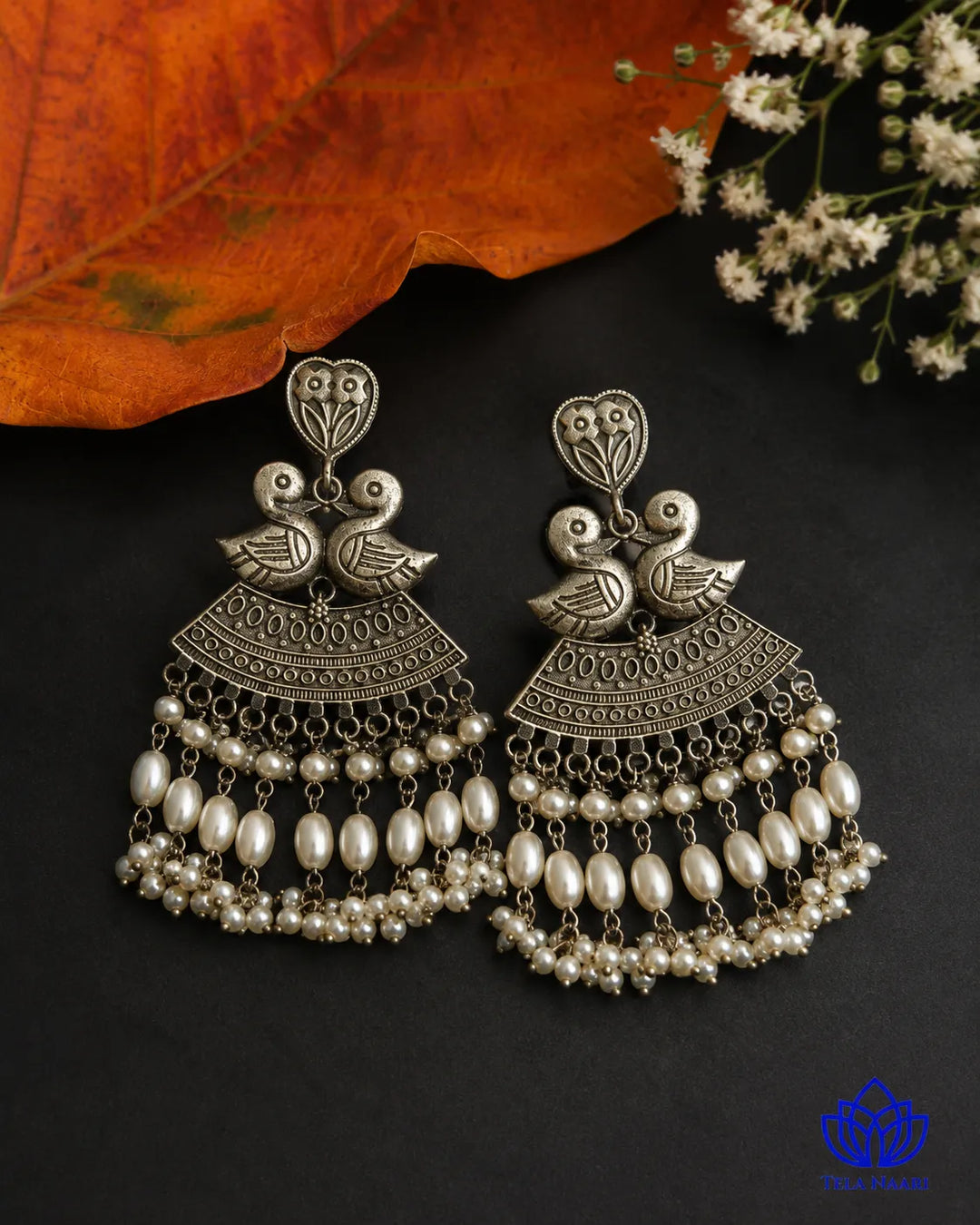 Quirky duck motif brings playful charm to this silver-plated earring.
