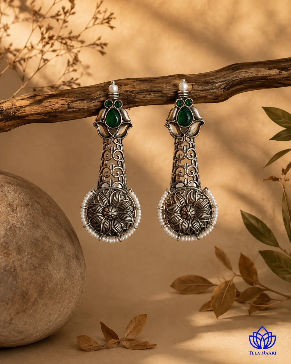 Rich patina covers the oxidised silver surface of this earring.
