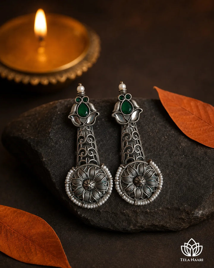 Timeless design combines oxidised silver with emerald pearl accents.
