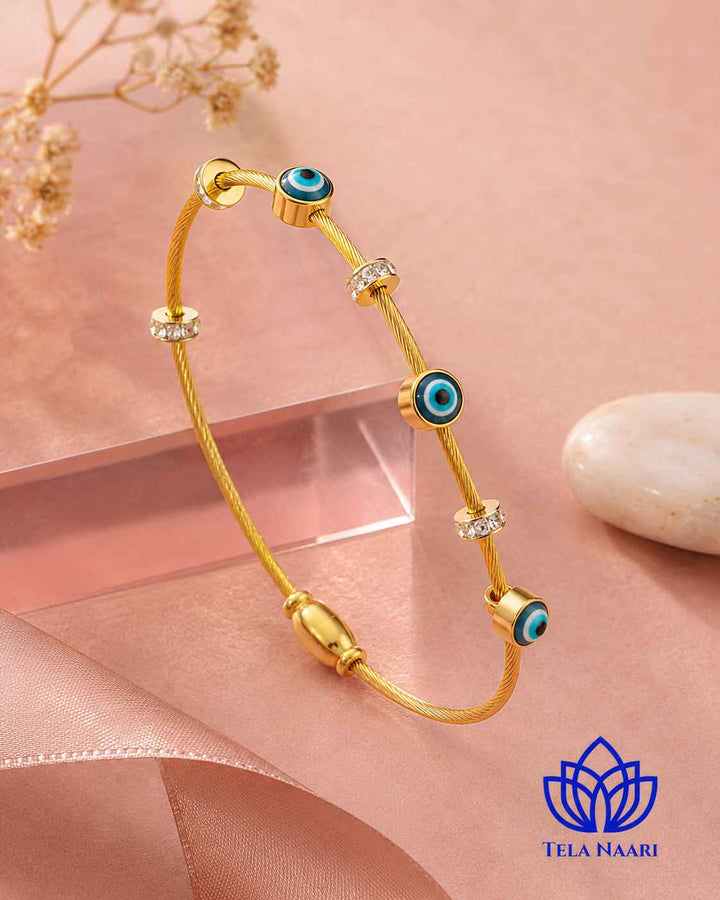 Radiant evil eye charm sits at the centre of this cuff.