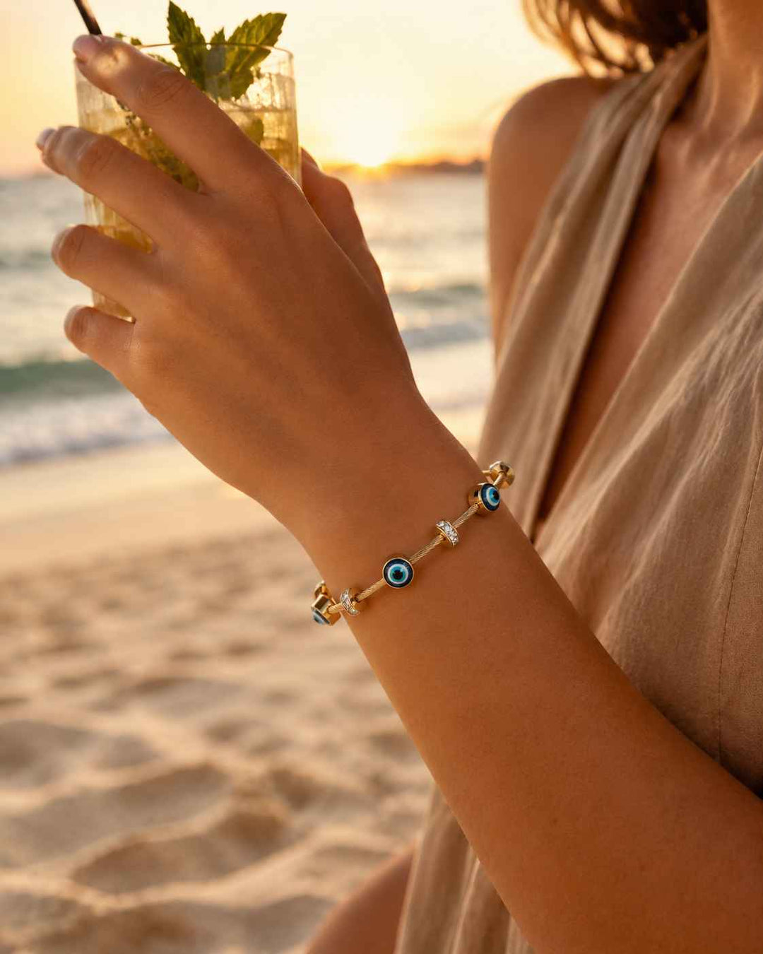 Protective evil eye motif adds a striking accent to this cuff.