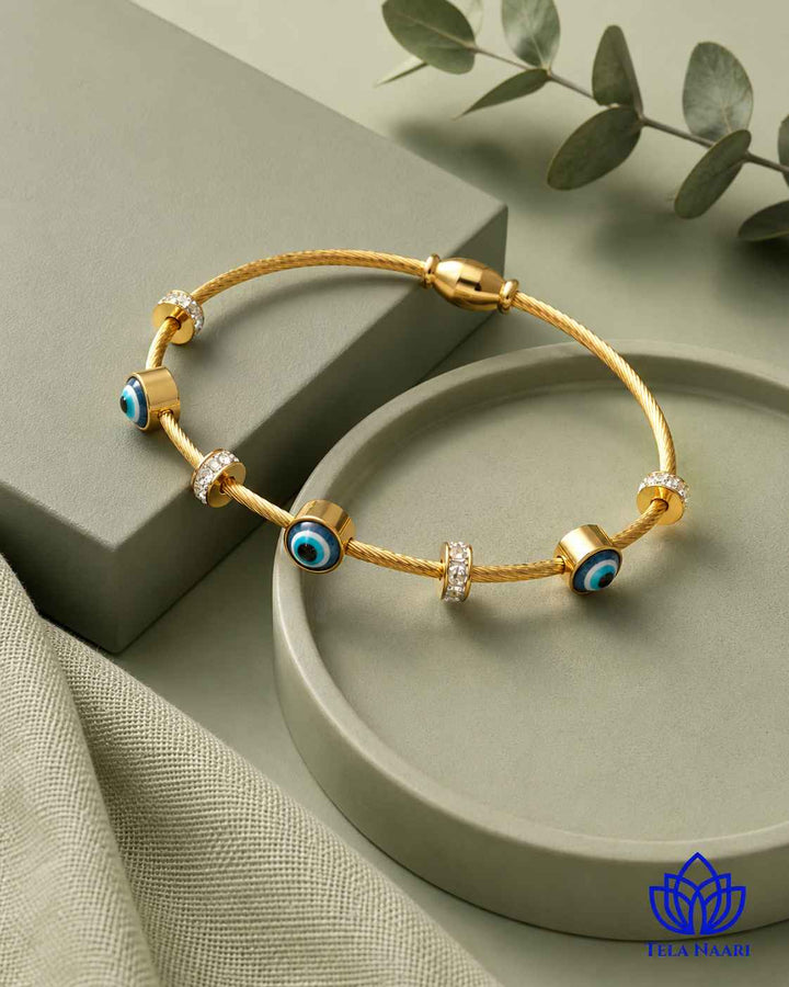 Polished gold-plated surface catches the light across this cuff.