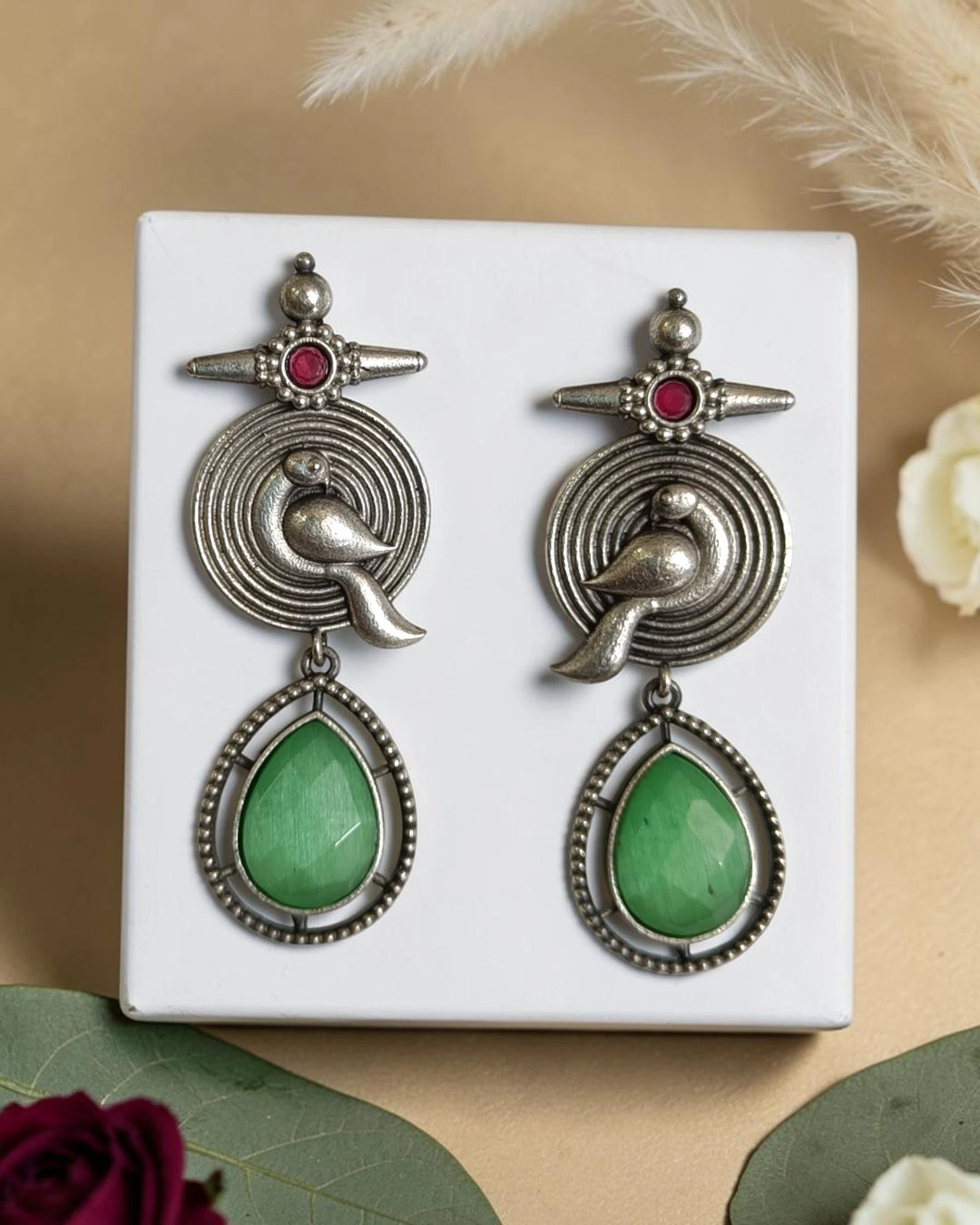 Artisanal bird motif detailing shapes the silhouette of this earring.