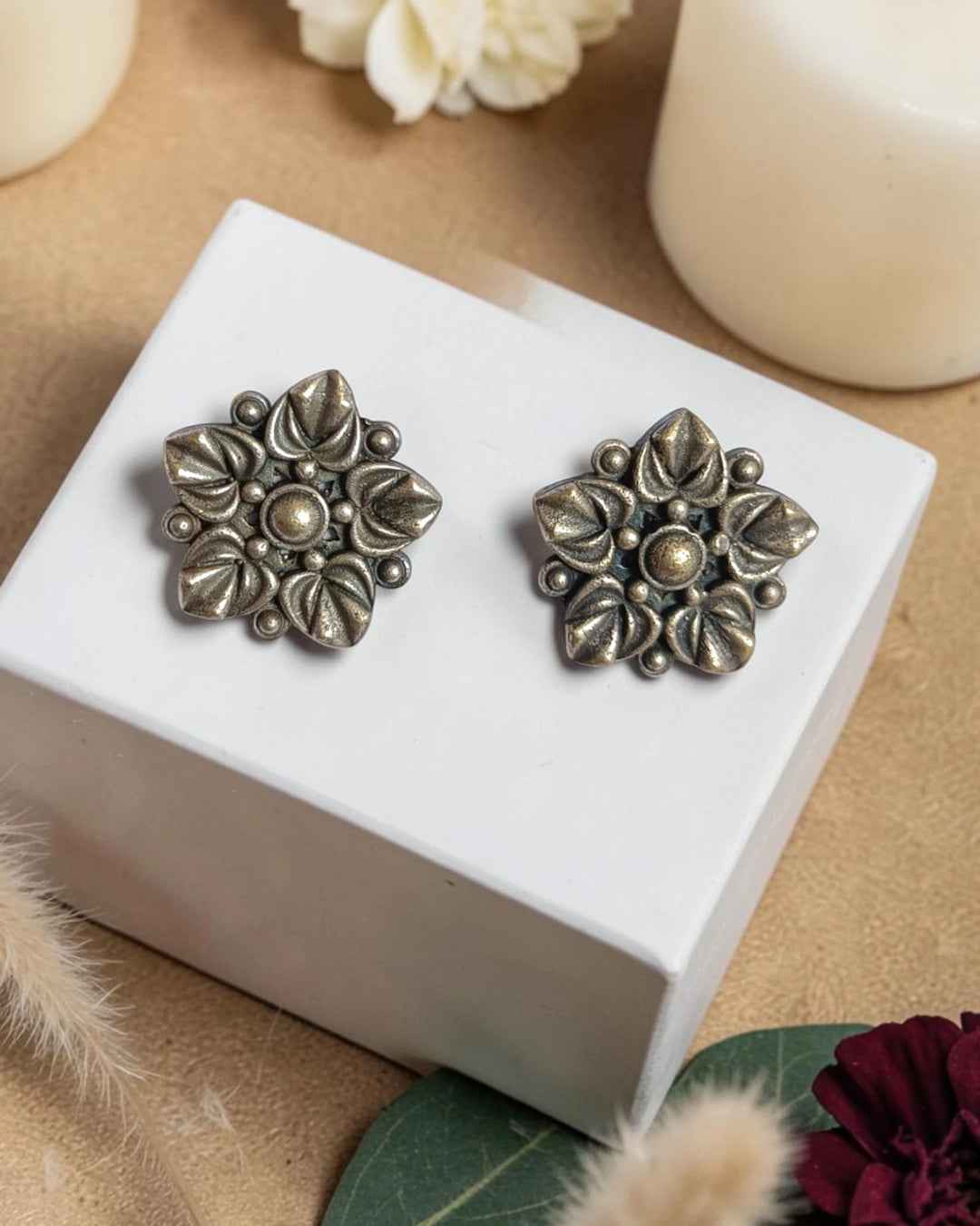 Vintage floral bloom detailing shapes the silhouette of this stud.