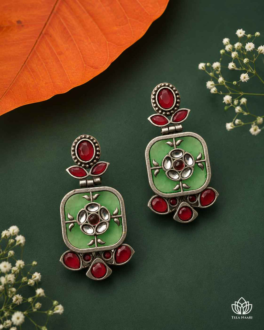 Sparkling silver-plated finish highlights the green dangler shape.