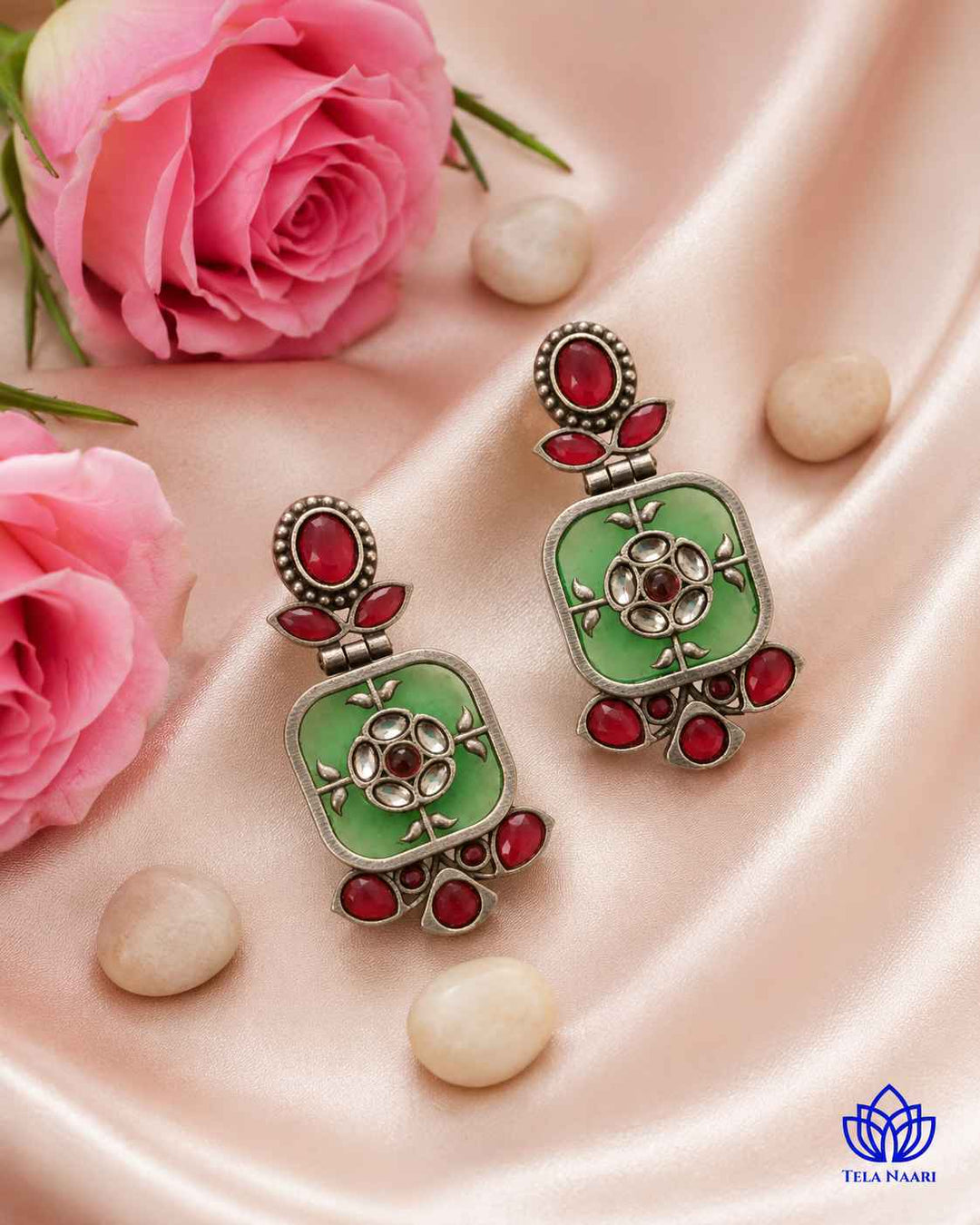 Green dangler earrings finished with a silver-plated shine.