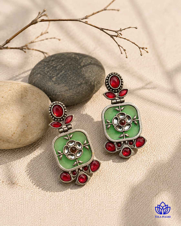 Lightweight brass earring features a silver-plated green dangler design.