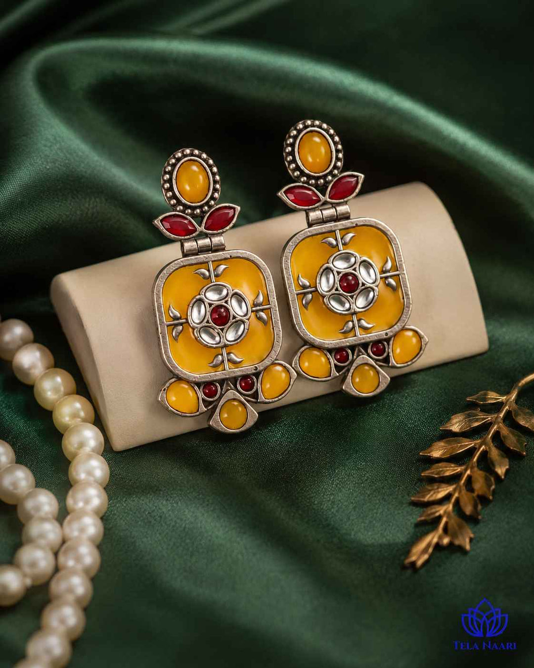 Delicate dangler design pairs yellow tones with a silver-plated finish.