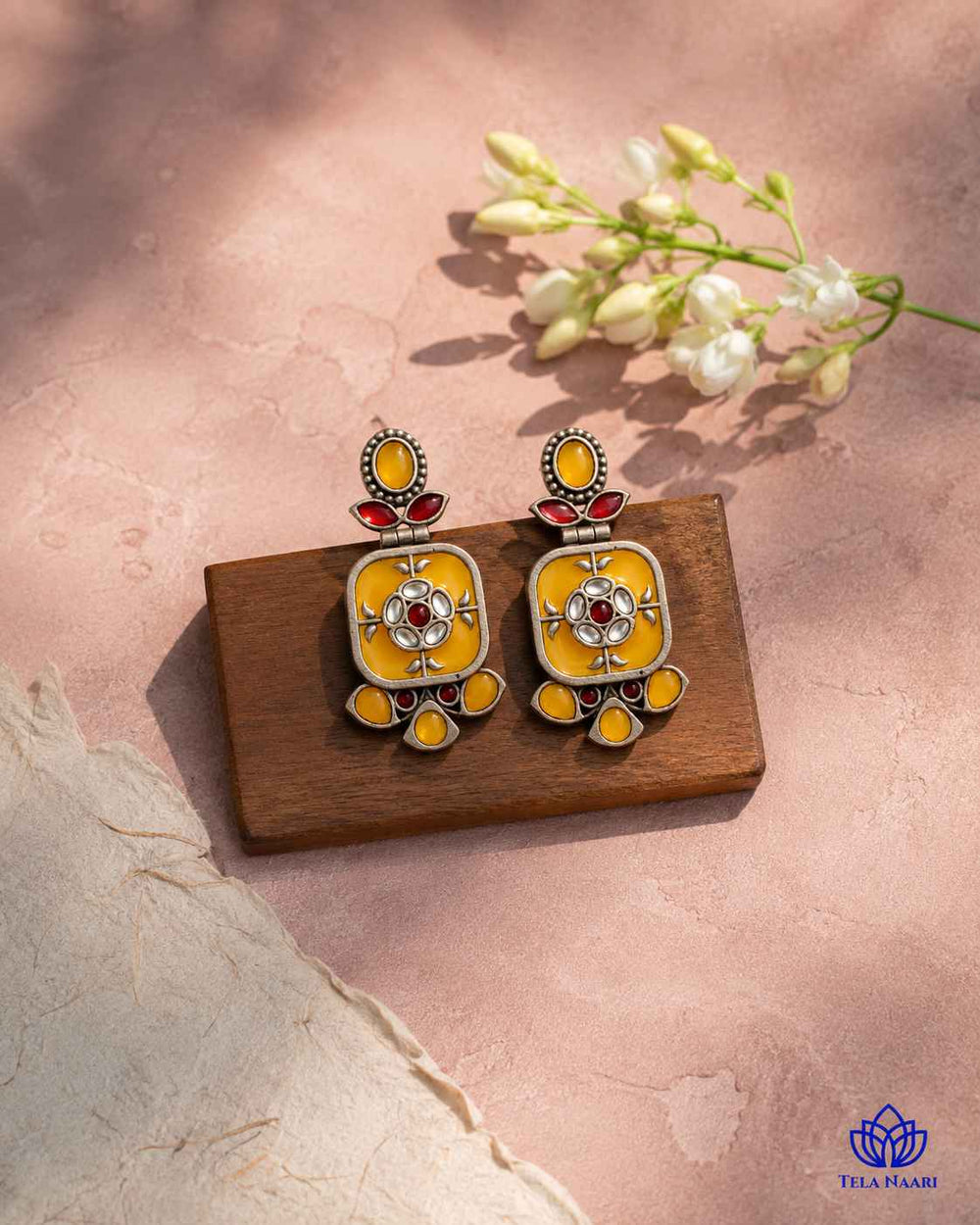 Silver-plated finish covers the surface of this yellow earring.
