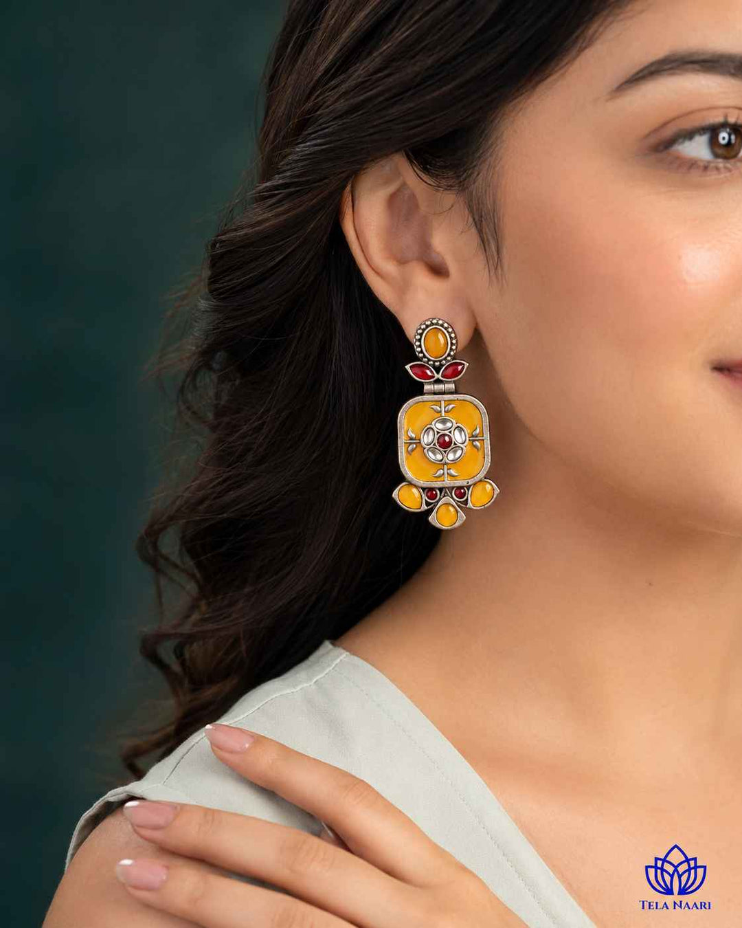 Push-back closure secures this silver-plated yellow earring in place.