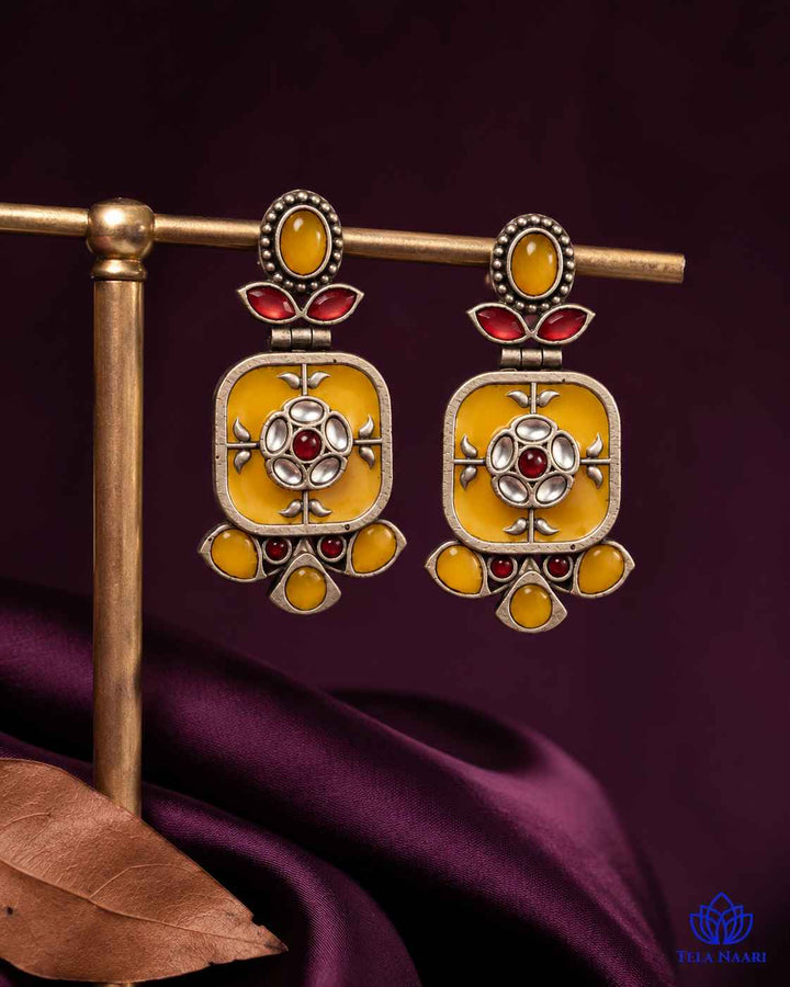 Brass construction supports the lightweight dangler design of this earring.