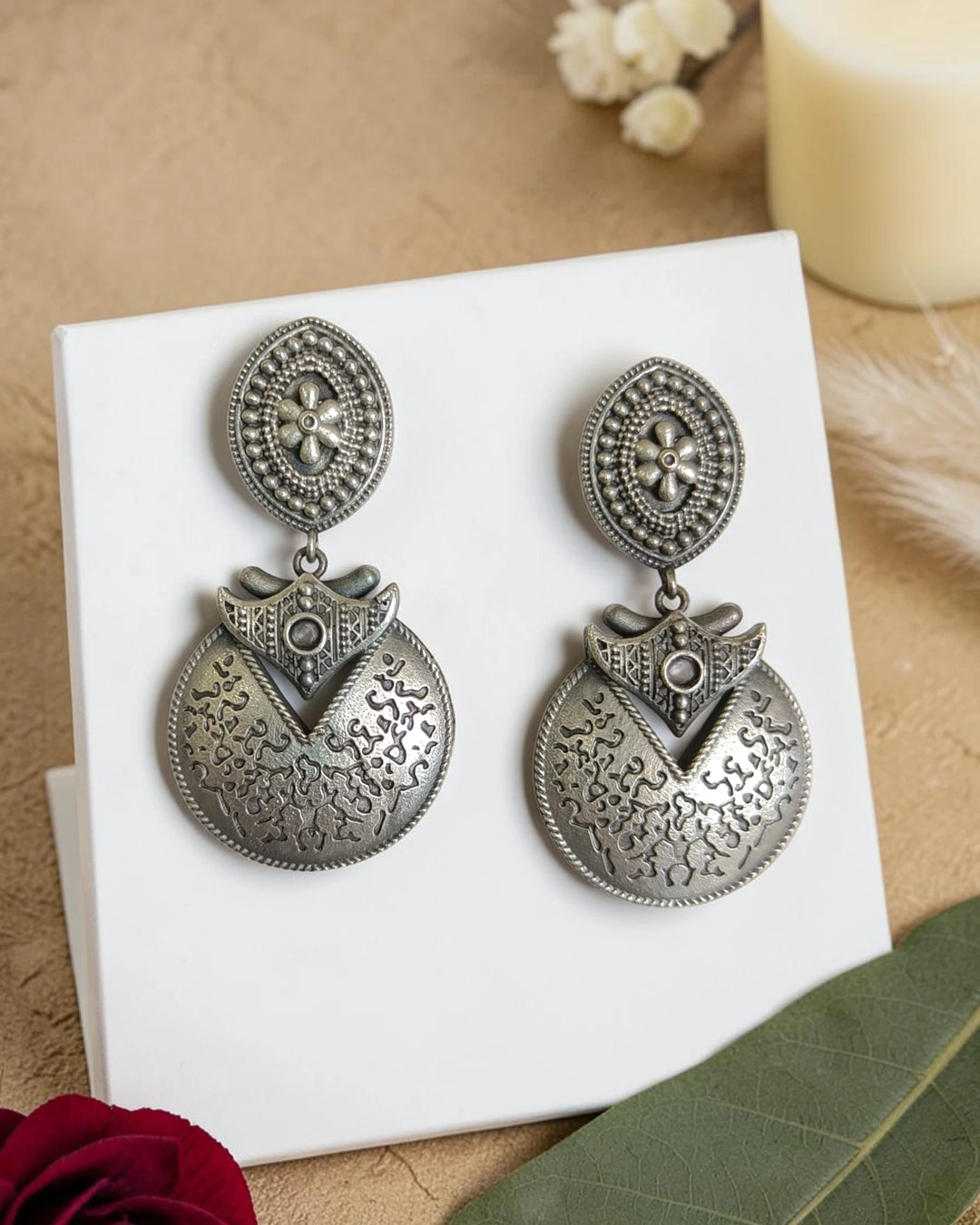 Sculptural disk shape defines the silhouette of this oxidised earring.