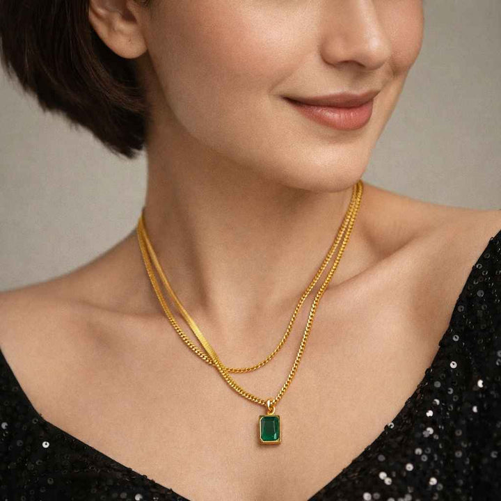 Emerald-toned pendant hangs from this layered stainless steel chain.