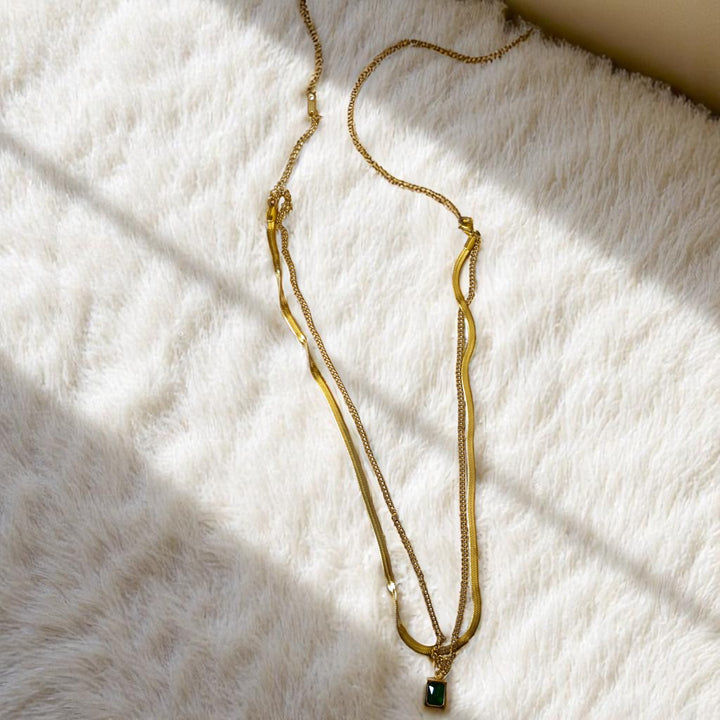 Layered design adds dimension to this emerald-toned pendant necklace.