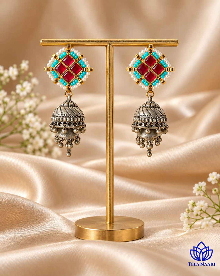 Glass bead accents decorate the surface of this jhumka.