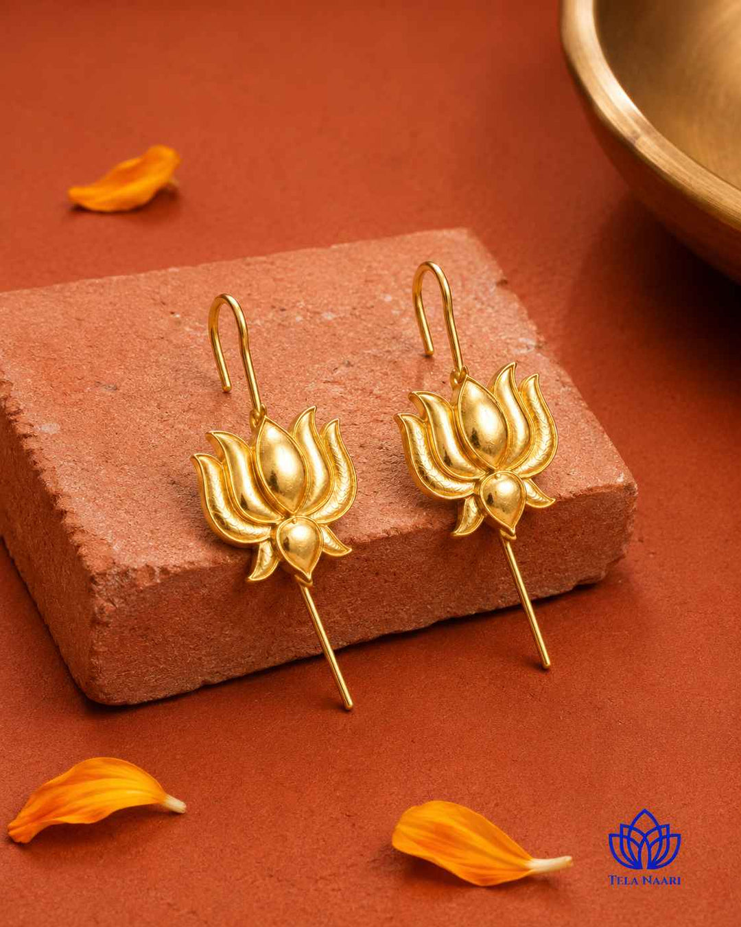 Plated surface catches the light across this lotus-motif earcuff.