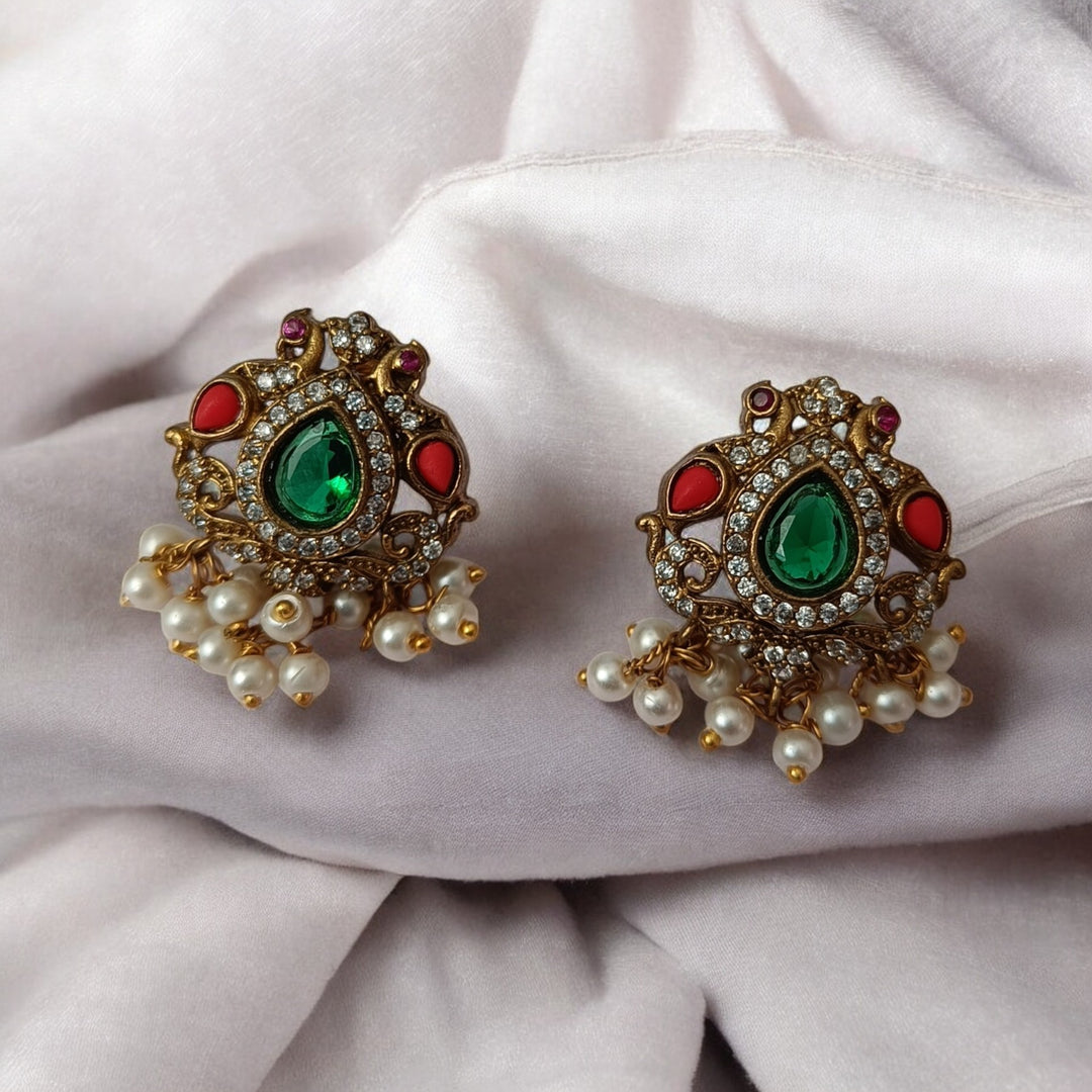 Matching earrings complete this green stone necklace set design.