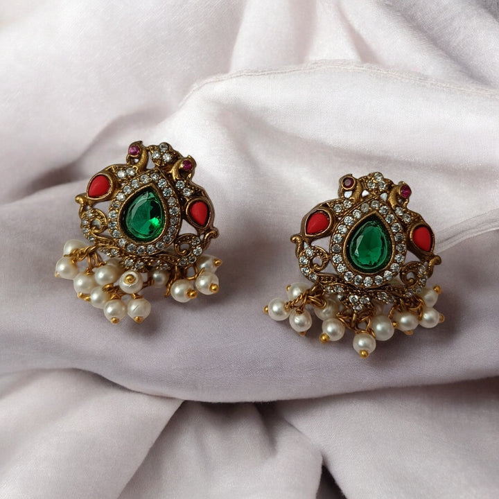 Matching earrings complete this green stone necklace set design.