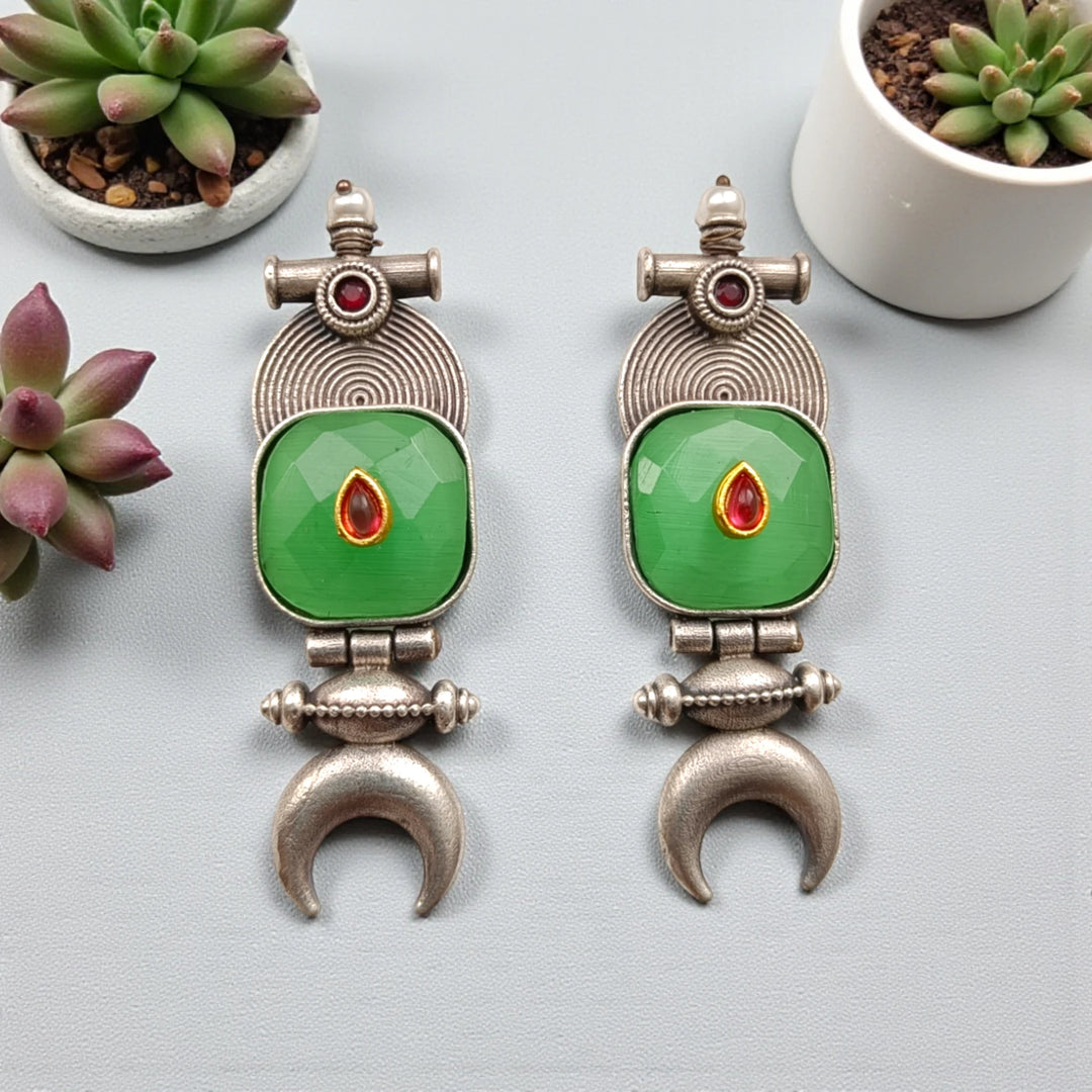 Silver-plated finish covers the surface of this half moon earring.
