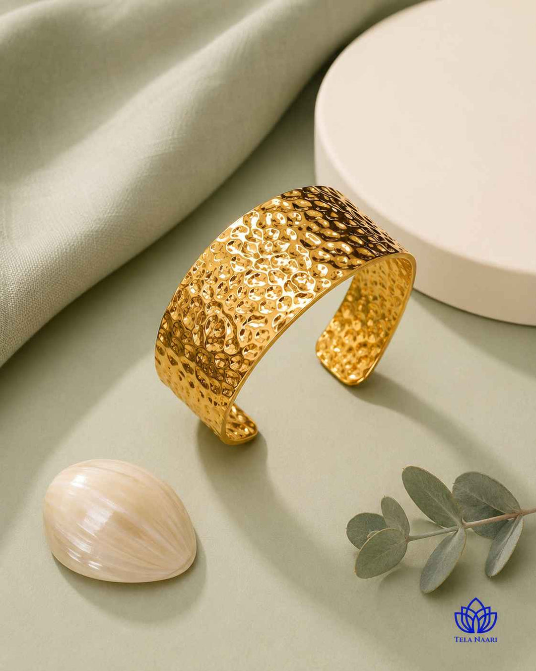 Bold hammered texturing shapes the surface of this gold cuff.