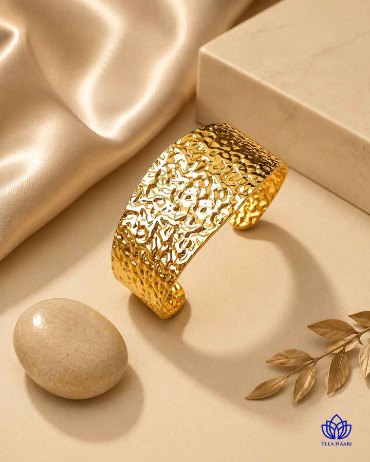 Statement finish highlights the hammered surface of this gold cuff.