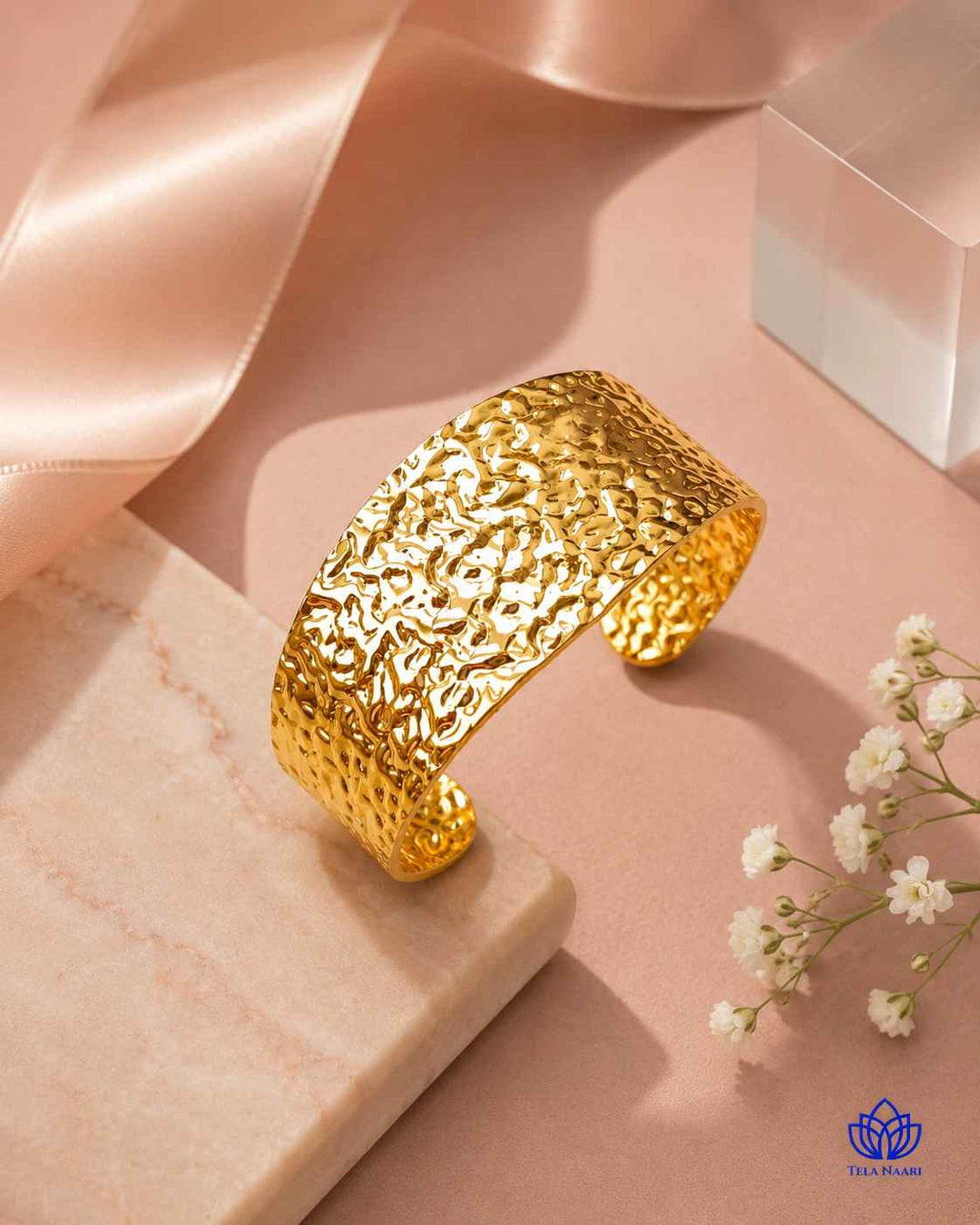 Textured hammering catches the light across this cuff bracelet.