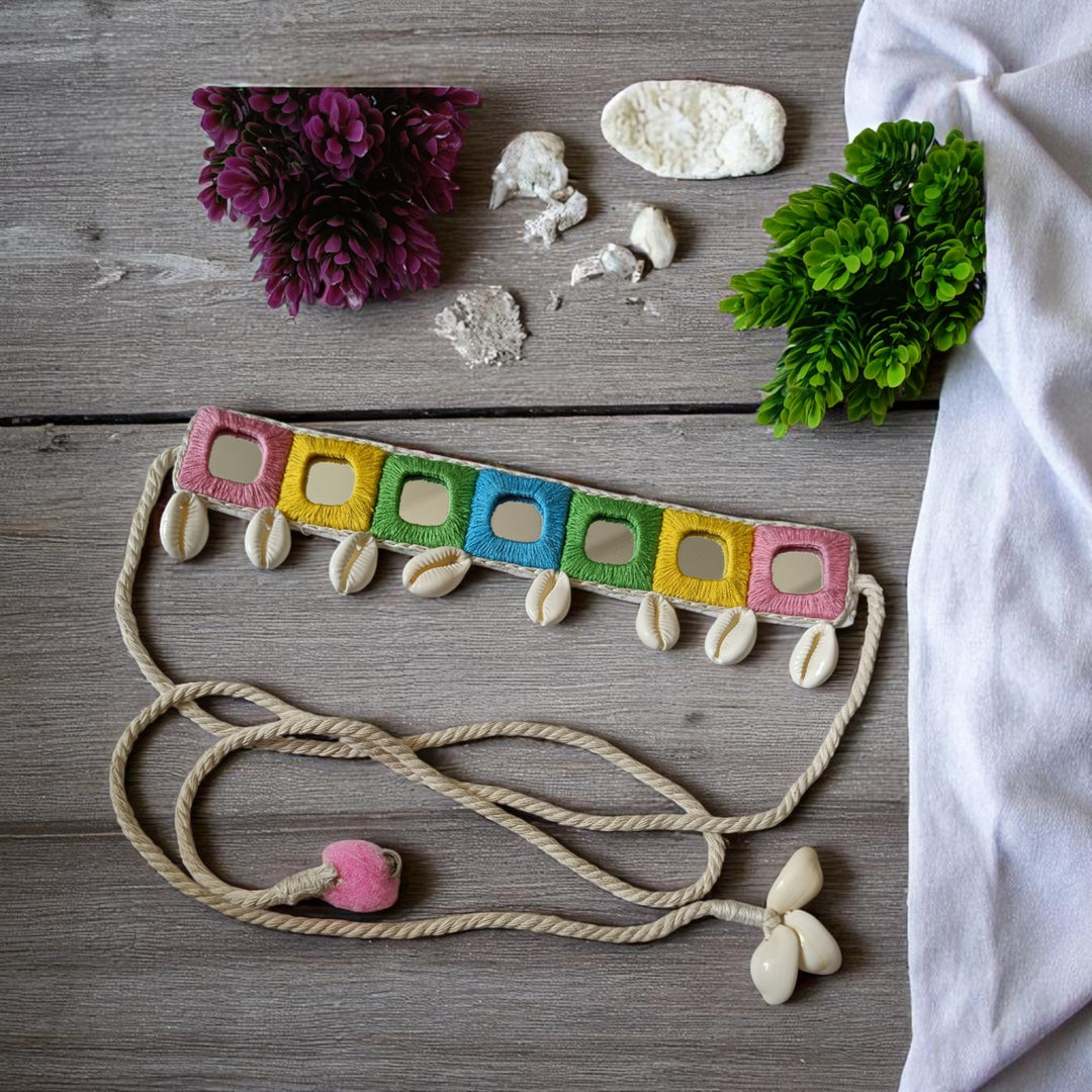 Cowrie shells decorate the surface of this pastel handmade choker.