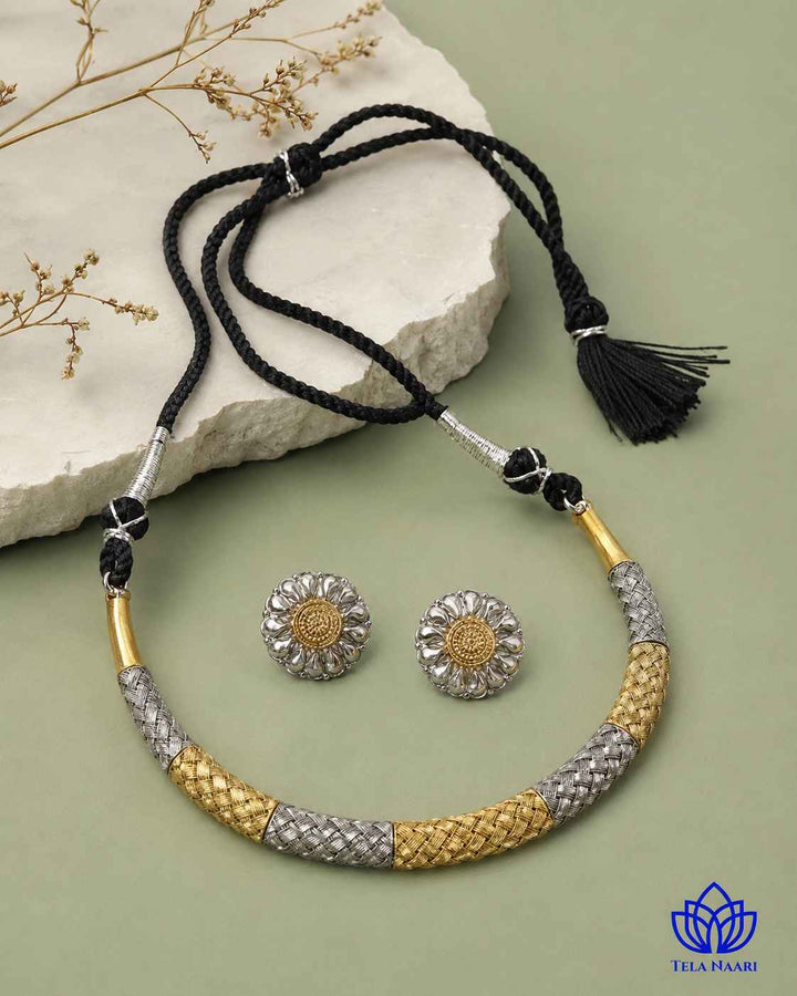 Matching earrings complete this dual-tone choker necklace set.