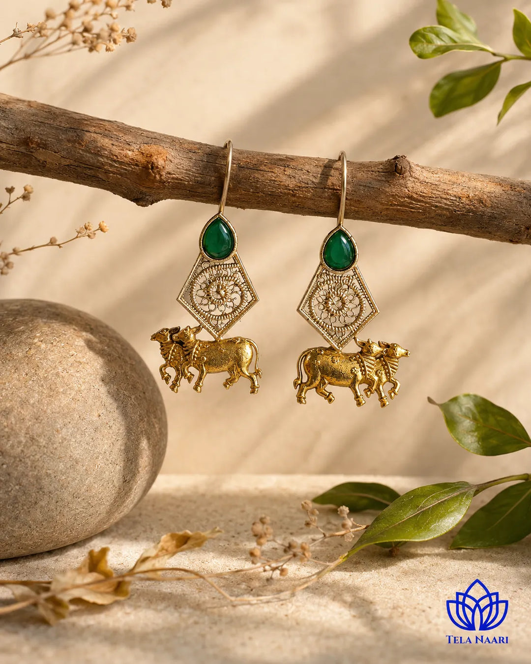 Devotional cow motif shapes the silhouette of this gold-plated earring.