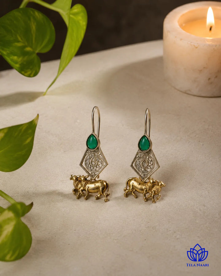 Push-back closure secures this gold-plated cow motif earring.