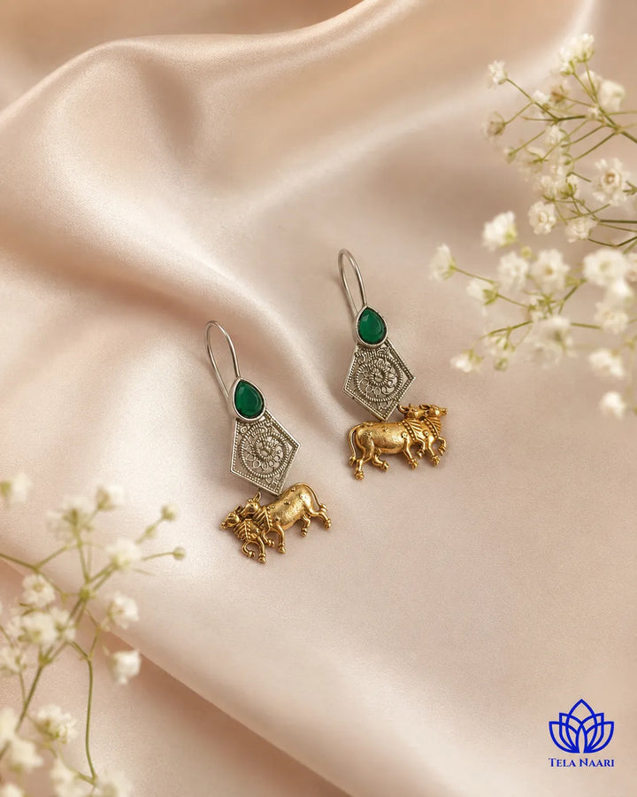 Refined detailing outlines the cow silhouette of this earring.